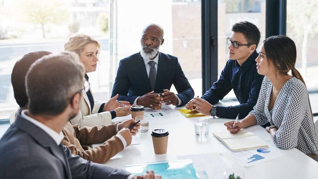 Senior leaders in a meeting discussing Skills in Demand visa changes and workforce planning.