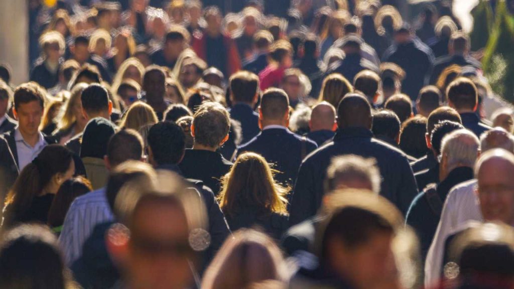 Crowd of people in a city street, representing the community whose acceptance forms a business’s social licence to operate.