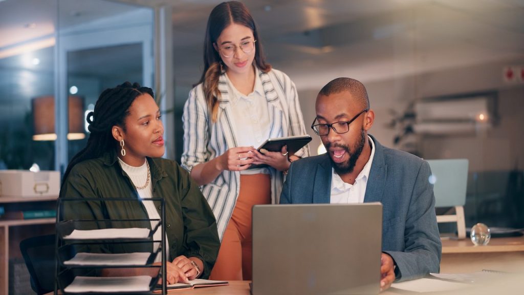HR professionals reviewing employee visa and compliance information in a workplace meeting