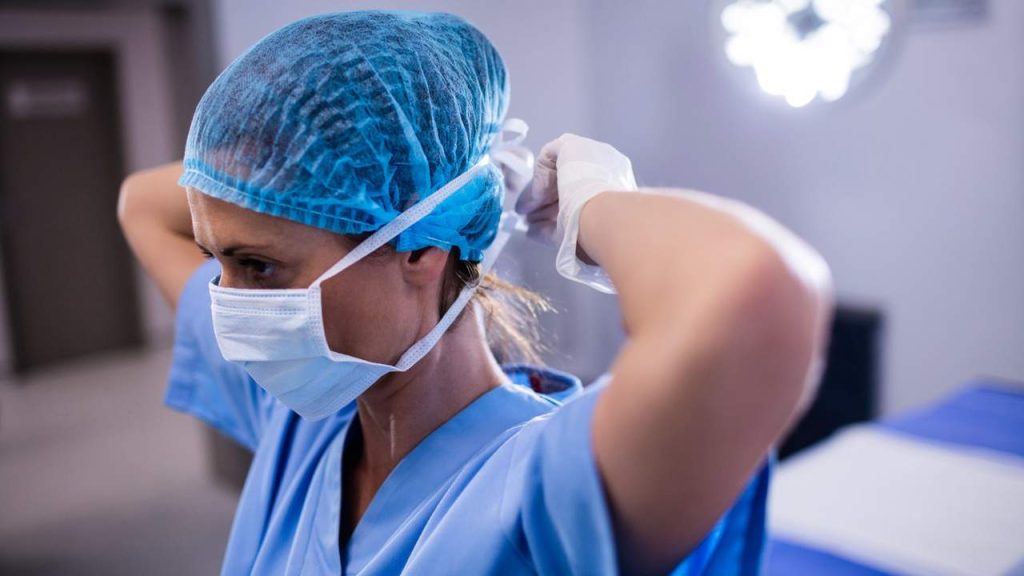 Registered nurse preparing for work in a hospital clinical setting