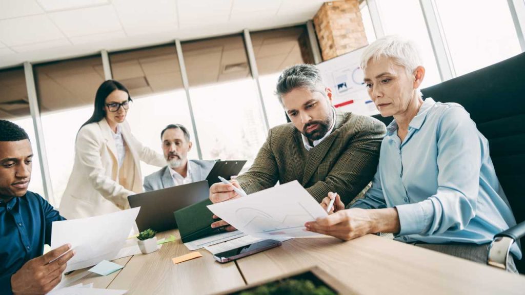Employer team reviewing visa application costs and salary thresholds before 1 July 2026.