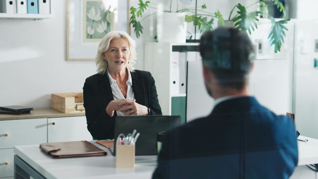 Employer interview discussion in a modern office, representing workforce planning under the Skills in Demand visa.